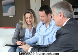 Couple with real-estate agent signing home investment contract