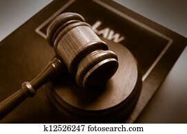 court gavel on top of a law book court gavel on top of a law book