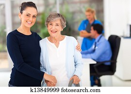 daughter and senior mother in doctors office