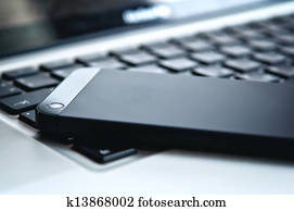 device technology. black phone and laptop keyboard