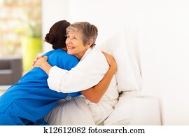 elderly woman hugging caregiver elderly woman hugging caregiver