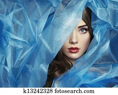 Fashion photo of beautiful women under blue veil Fashion photo of beautiful women under blue veil