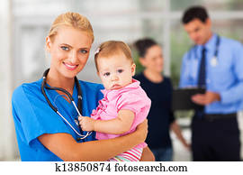 female nurse holding baby girl