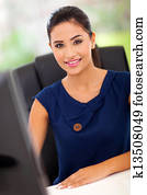female office worker by her work station