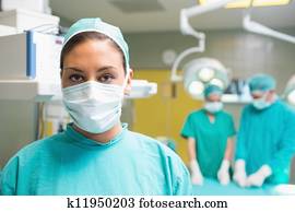 Female surgeon posing with her uniform