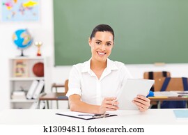 female teacher holding a tablet computer