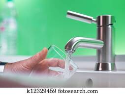 Fillig glass of mains water, drinking water Fillig glass of mains water, drinking water