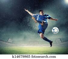 football player striking the ball football player striking the ball