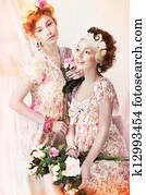 Freshness. Two Young Pretty Women in Classic Vintage Dresses with Flowers. Pin-up Style