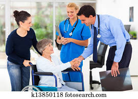 friendly medical doctor greeting senior patient