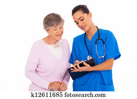 friendly young nurse helping senior woman