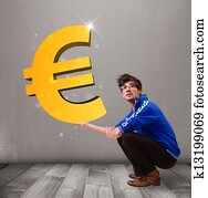 Good-looking boy holding a big 3d gold euro sign Good-looking boy holding a big 3d gold euro sign