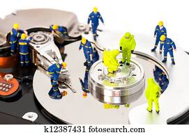 Group of engineers maintaining hard drive Group of engineers maintaining hard drive