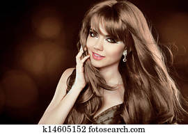 Hairstyle. Brown Hair. Attractive smiling girl with long Curly Hair. Happy smiling woman.