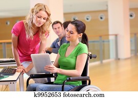 Handicapped person at work with electronic tablet