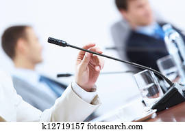 Hands of businessman holding microphone