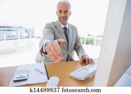 Happy businessman reaching arm out for handshake