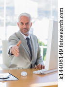 Happy businessman reaching out for 