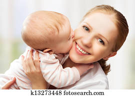 Happy cheerful family. Mother and baby kissing