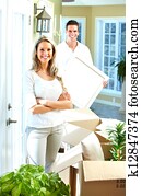 Happy couple moving in a new house.