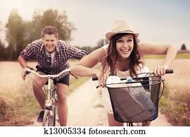 Happy couple racing on bikes
