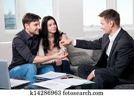 Happy couple with real estate agent Happy couple with real estate agent