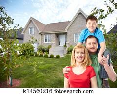 Happy family near new house.