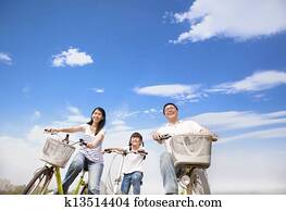 happy family riding bicycle with cloud background happy family riding bicycle with cloud background