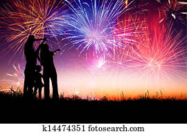 happy family standing on the hill and watching the fireworks happy family standing on the hill and watching the fireworks