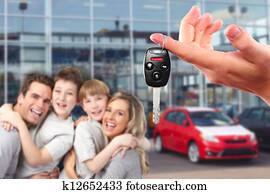 Happy family with a new car keys.