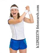 Happy female tennis player rejoicing success