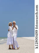 Happy Senior Couple Dancing on Tropical Beach