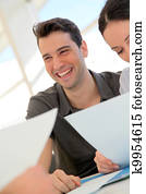 Happy young couple signing property purchase contract 