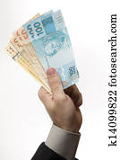 holding a Brazilian money.
