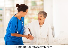 home caregiver helping senior woman