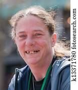 Homeless woman smiling with bad teeth