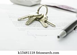 House keys on a contract of house sale House keys on a contract of house sale
