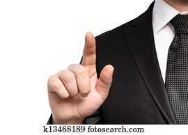 Isolated businessman in a suit and tie points the finger at an object