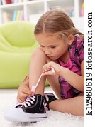 Little girl ties shoes
