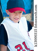 LIttle league baseball player in dugout