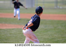 Little league player throwing ball