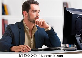 Man Looking At A Computer Monitor Man Looking At A Computer Monitor