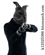 man with rabbit mask hunting with shotgun silhouette portrait