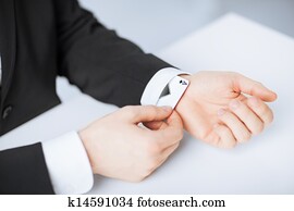 mans hand hiding ace in the sleeve