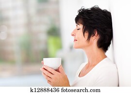 mature woman enjoying a cup of coffee
