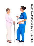 medical nurse talking to senior woman 