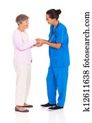 medical worker greeting senior woman