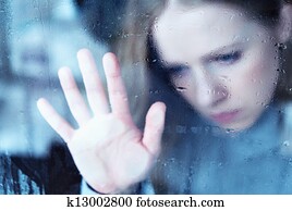 melancholy and sad girl at the window in the rain melancholy and sad girl at the window in the rain