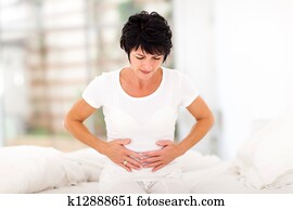 mid age woman having stomach pain mid age woman having stomach pain