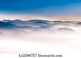 Misty mountains landscape view with blue sky Misty mountains landscape view with blue sky